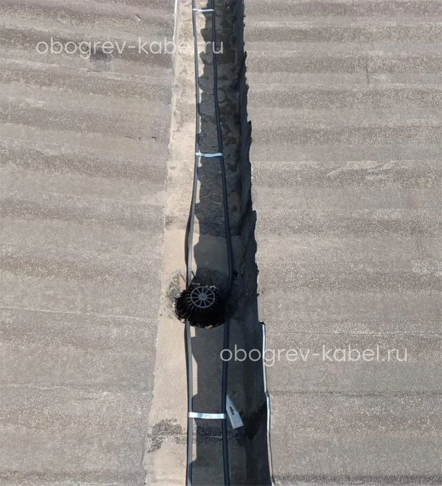 Обогрев внутренней водосточной трубы на кровле с желобом между двумя зданиями